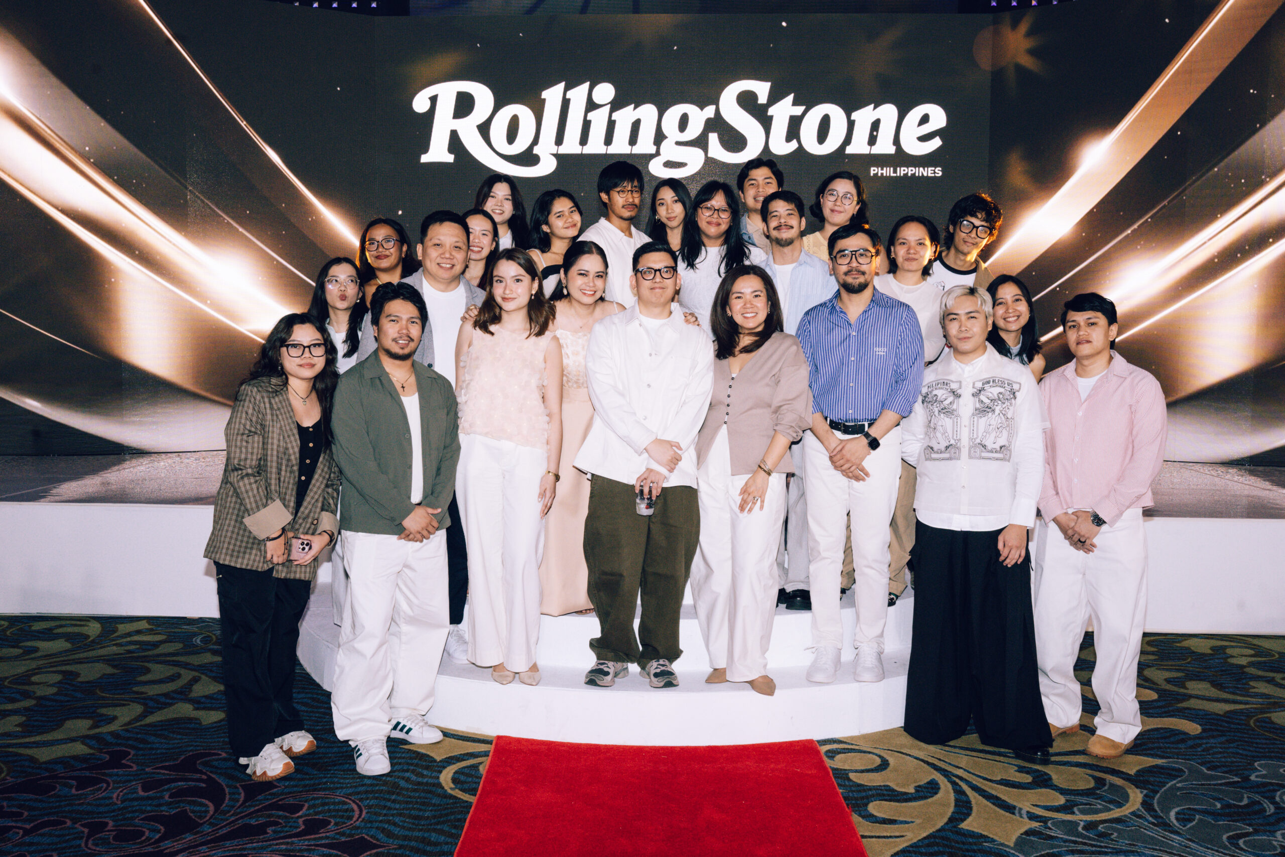 Group of people posing on a stage in front of a Rolling Stone Philippines backdrop.