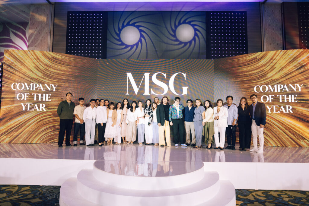 Group of award winners and staff posing on stage in front of a large MSG backdrop reading 'Company of the Year' and 'MSG' logos.