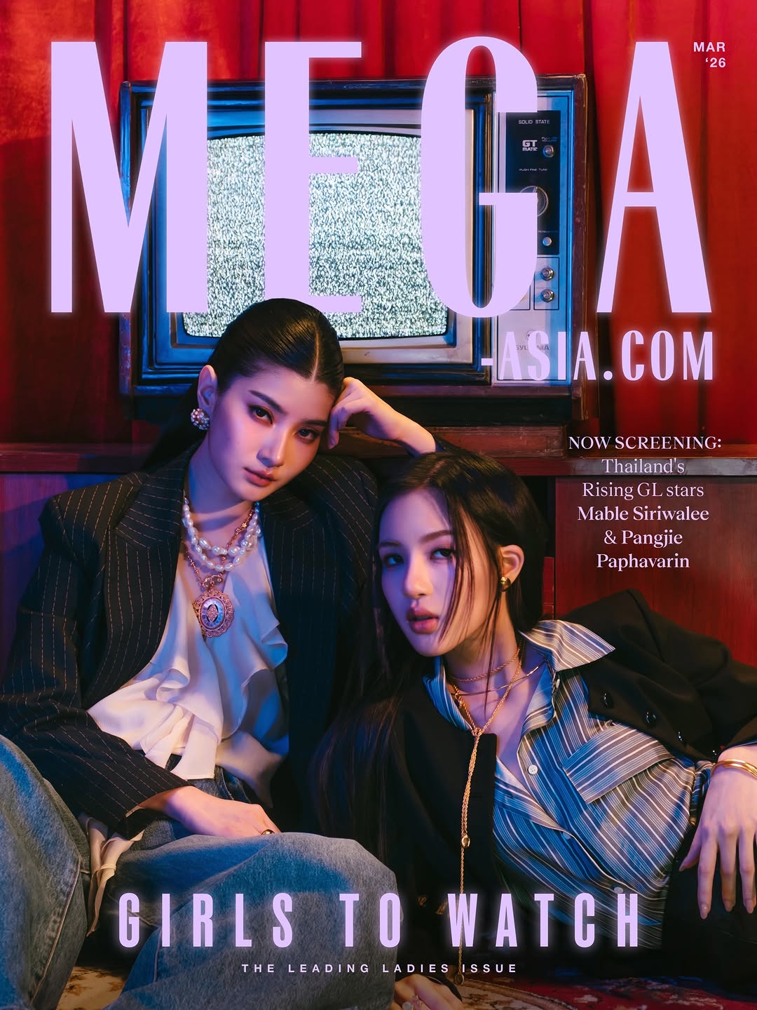 Magazine cover featuring two fashionable women posing in a retro TV setting with large MEGA typography