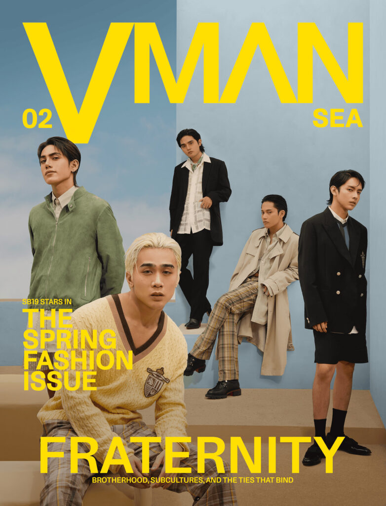 Magazine cover featuring five male models in stylish spring outfits posed against a blue backdrop, with a bold yellow 'V MAN' title and 'The Spring Fashion Issue' text.