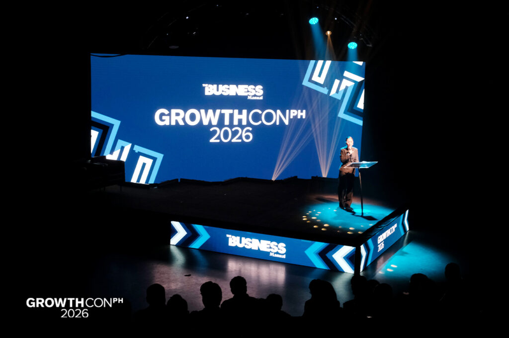 Stage presentation at Growth Con PH 2026 with a speaker at a podium and a large blue screen displaying 'GROWTHCON PH 2026'